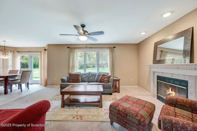 a kitchen with granite countertop a refrigerator a stove a sink a dining table and chairs with wooden floor