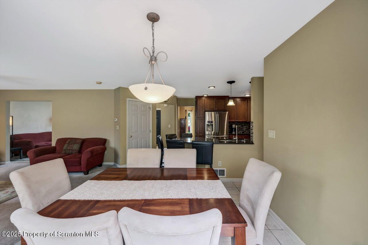 104 Beech Tree Circle Clarks Summit, PA 18411 - Photo 18 of 91 a view of a dining room with furniture and wooden floor