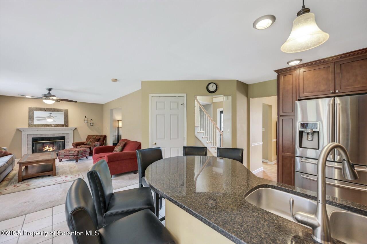 104 Beech Tree Circle Clarks Summit, PA 18411 - Photo 21 of 91 a kitchen with stainless steel appliances granite countertop a table chairs in it and a refrigerator