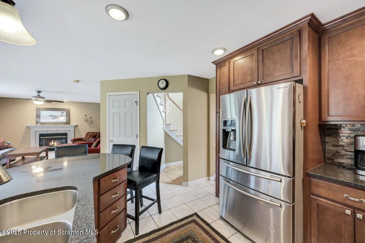 104 Beech Tree Circle Clarks Summit, PA 18411 - Photo 26 of 91 a kitchen with stainless steel appliances a refrigerator a table and chairs