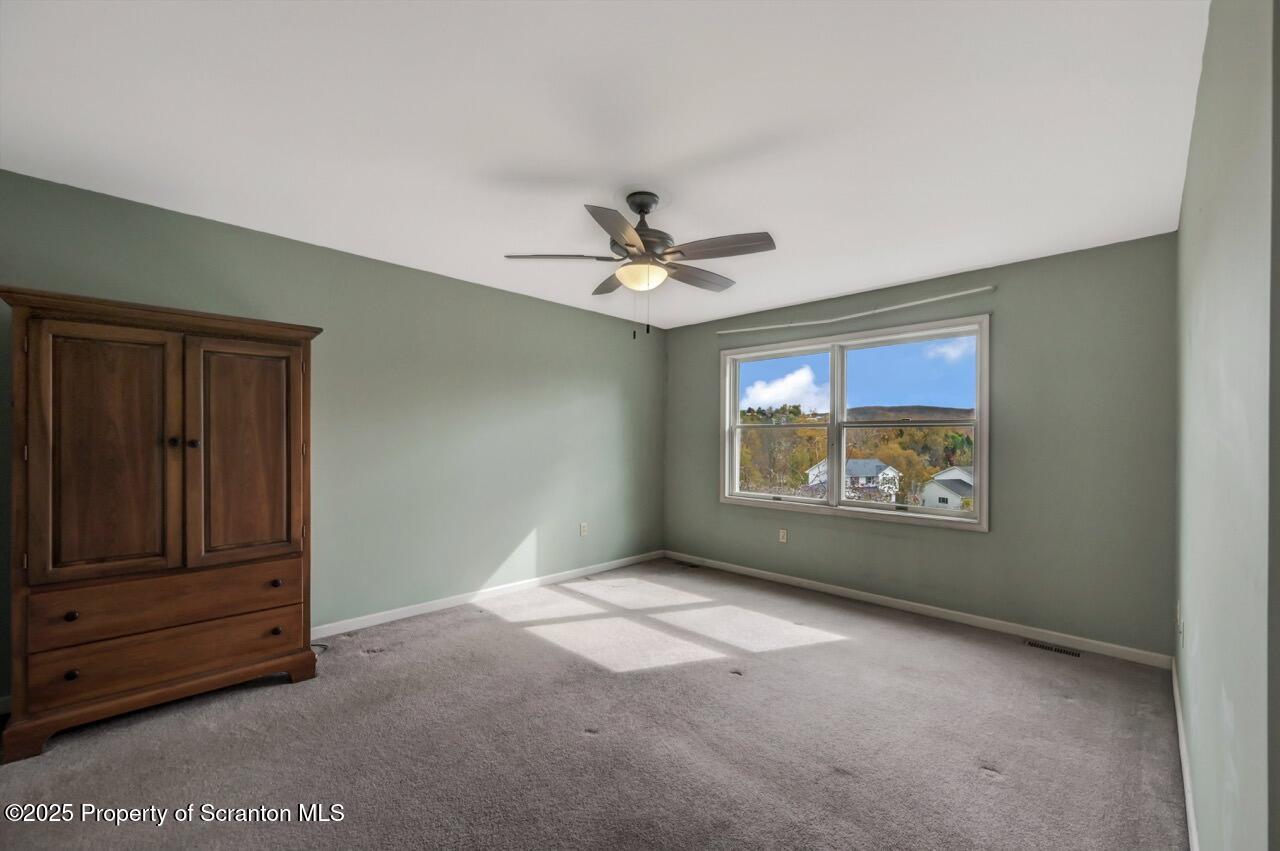 104 Beech Tree Circle Clarks Summit, PA 18411 - Photo 48 of 91 an empty room with windows and ceiling fan