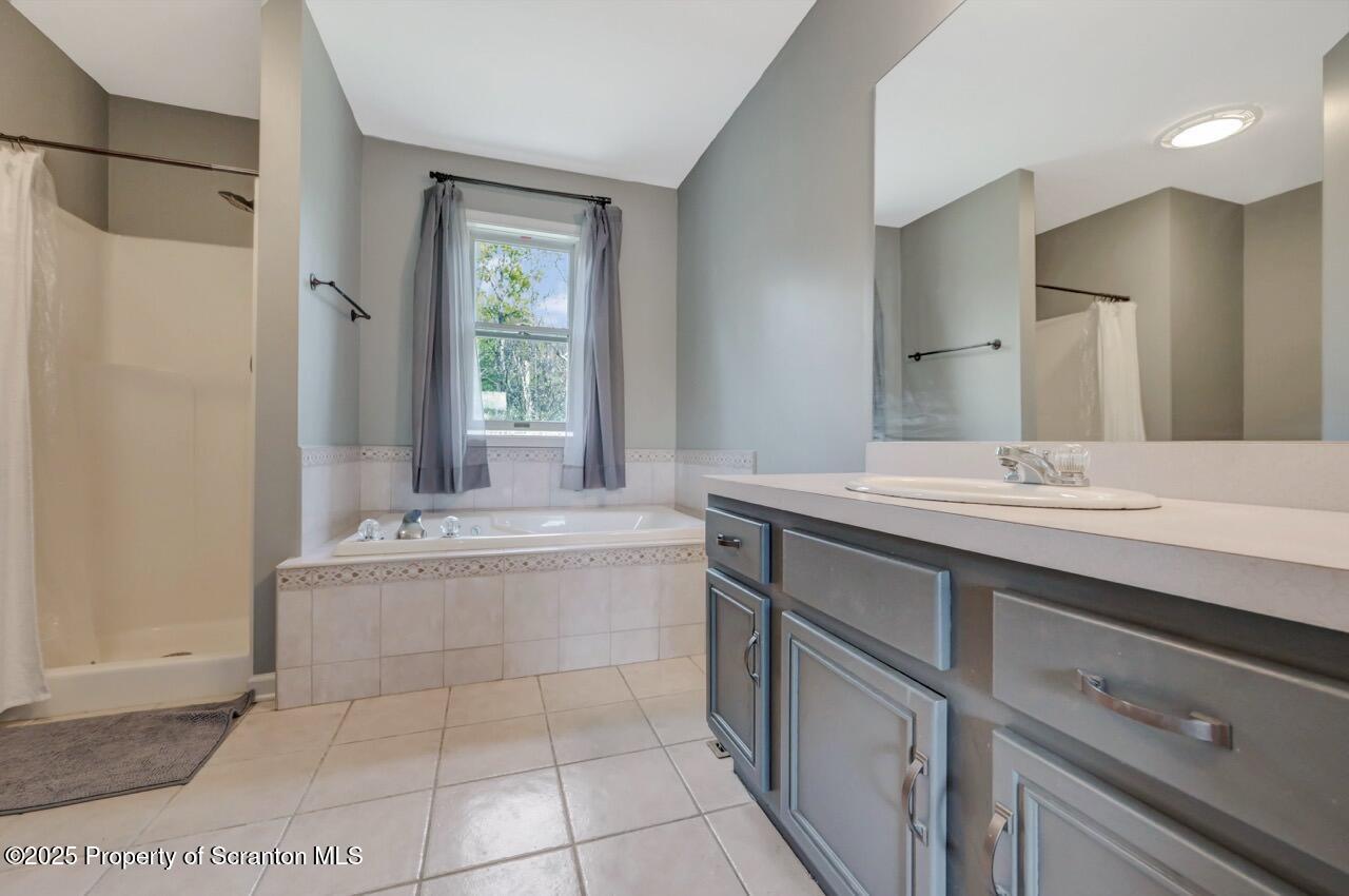104 Beech Tree Circle Clarks Summit, PA 18411 - Photo 52 of 91 a bathroom with a granite countertop bathtub sink vanity and mirror