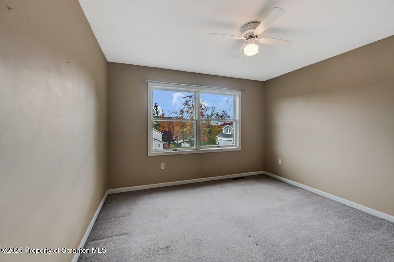 104 Beech Tree Circle Clarks Summit, PA 18411 - Photo 70 of 91 an empty room with windows and ceiling fan view