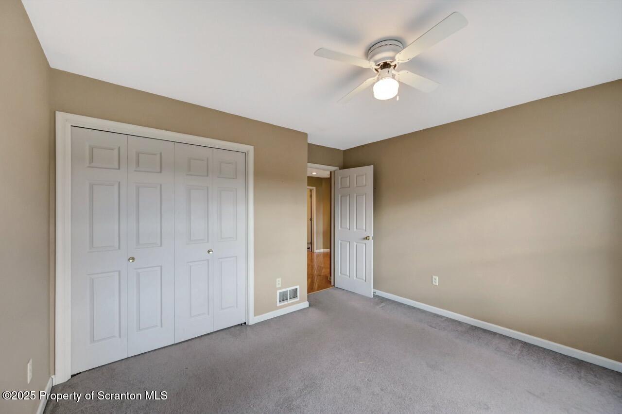 104 Beech Tree Circle Clarks Summit, PA 18411 - Photo 72 of 91 an empty room with closet and a ceiling fan