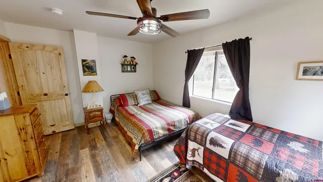 a bedroom with two beds and a window