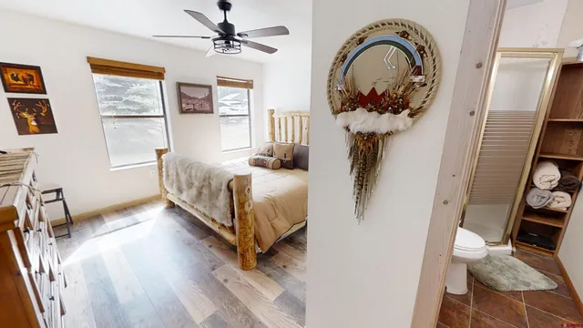 a bedroom with a bed and a chandelier