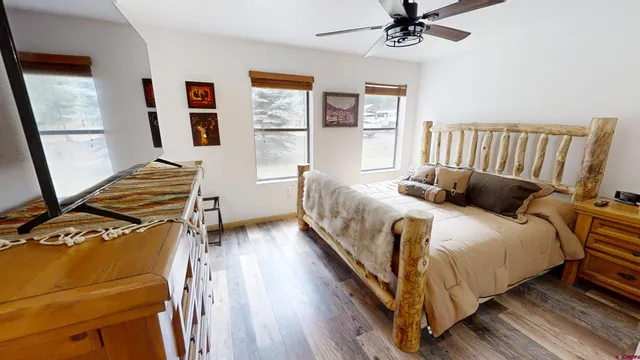 a bedroom with bed and wooden floor
