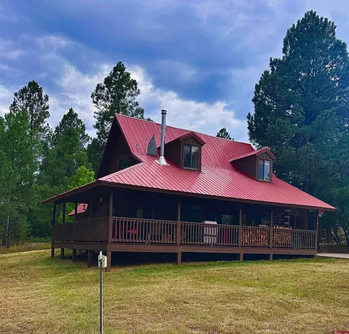 a front view of a house with a garden and deck