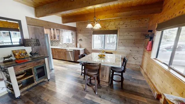 a dining room with furniture and wooden floor