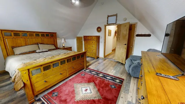 a bedroom with a bed and a mirror