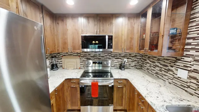 a kitchen with granite countertop a sink and a stove top oven