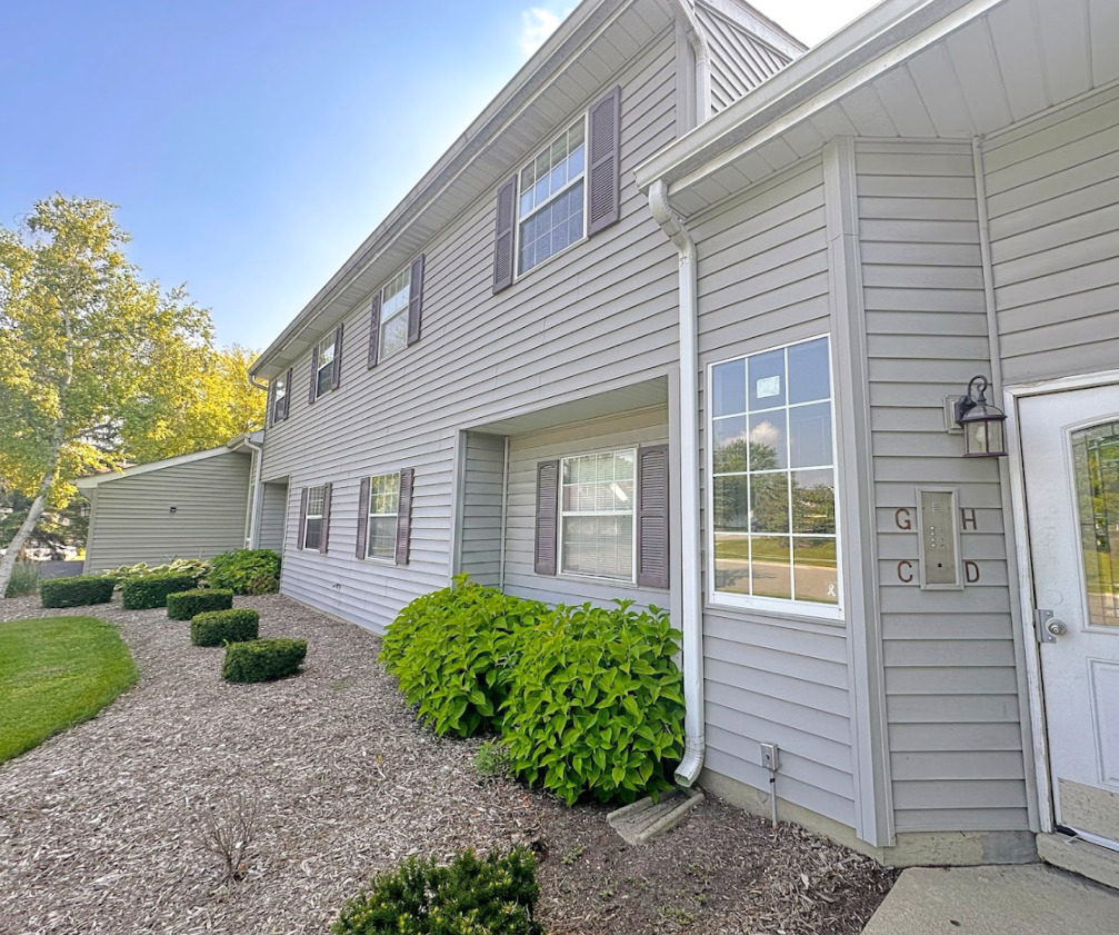 8 Gant Circle, Unit D Streamwood, IL 60107 - Photo 1 of 12 a view of a house with brick walls and potted plants