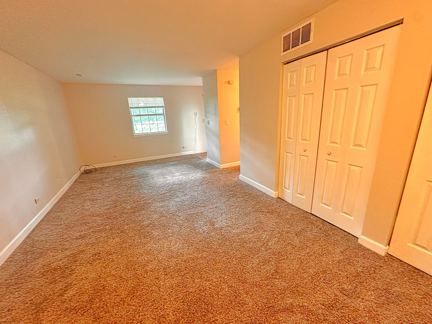 8 Gant Circle, Unit D Streamwood, IL 60107 - Photo 2 of 12 a view of an empty room with a window