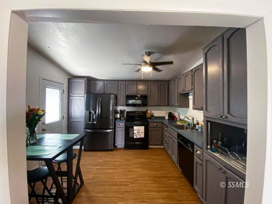 333 North Helena Street Ridgecrest, CA 93555 - Photo 9 of 35 a kitchen with granite countertop a refrigerator stove top oven dining table and chairs