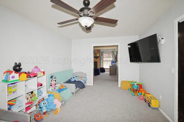 a playing room with toys and a flat screen tv