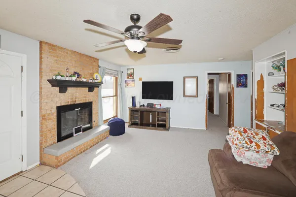 a living room with furniture and a fireplace