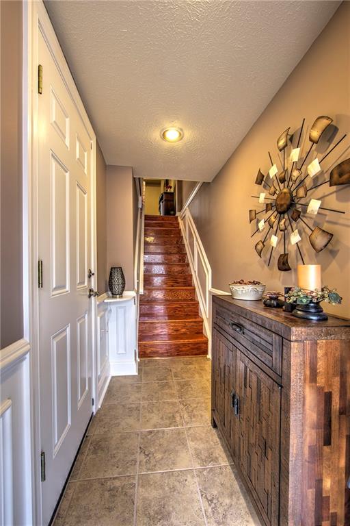 5497 Library Road, Unit 5 Bethel Park, PA 15102 - Photo 2 of 15 First floor entry boasts ceramic tile floors, note the hardwood staircase, neutral tones.