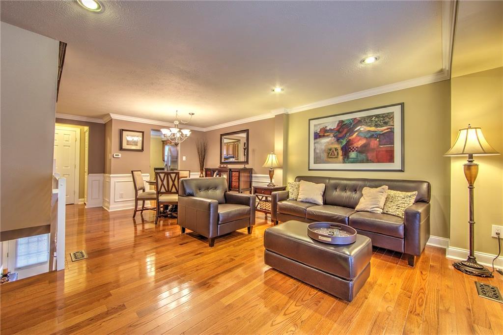 5497 Library Road, Unit 5 Bethel Park, PA 15102 - Photo 3 of 15 Living room/dining room combination boasts beautiful hardwood floors, crown molding, modern tones, wainscoting.