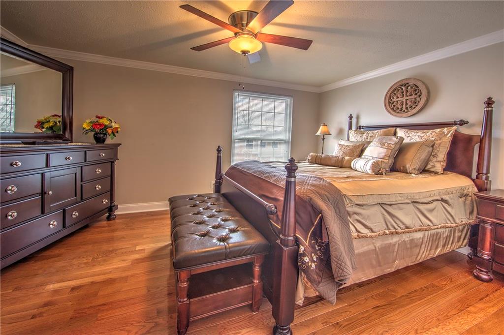5497 Library Road, Unit 5 Bethel Park, PA 15102 - Photo 10 of 15 Beautiful master bedroom featuring hardwood floors, crown molding, ceiling fan, neutral tones.
