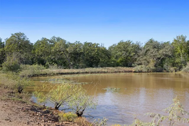 a view of a lake with a yard