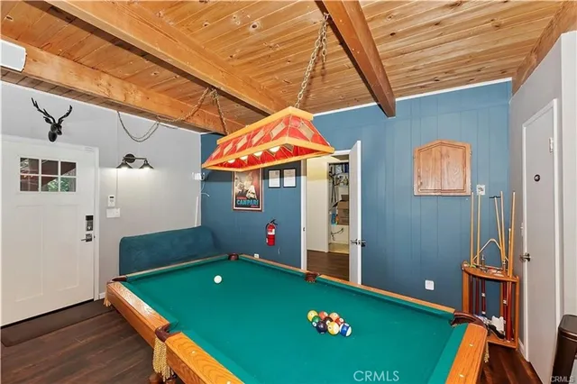 a room with pool table and windows