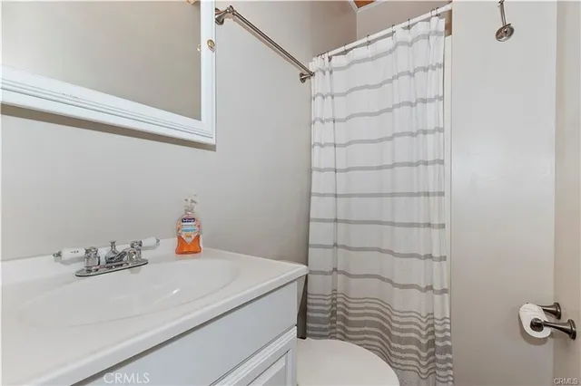 a bathroom with a sink and a shower curtain