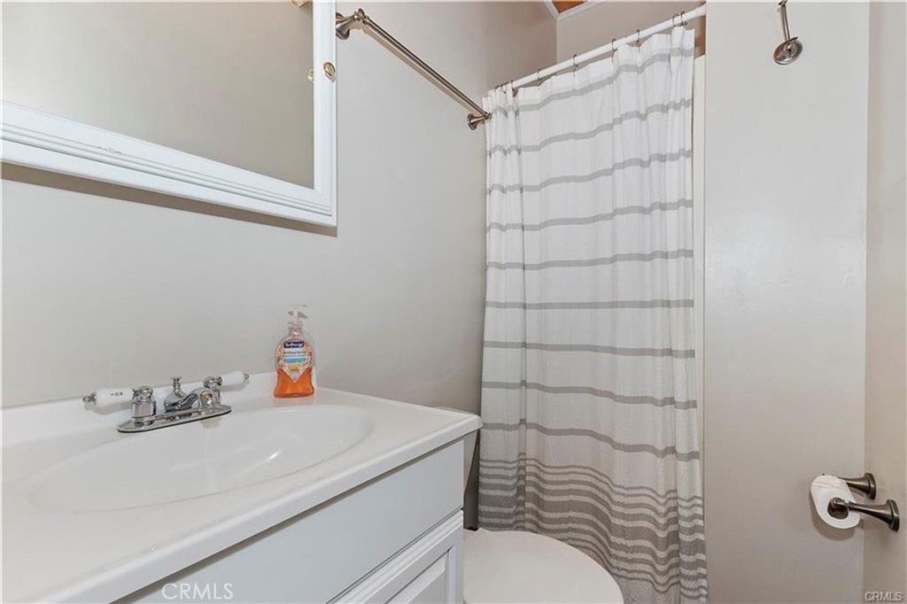 28393 Larchmont Lane Lake Arrowhead, CA 92352 - Photo 18 of 25 a bathroom with a sink and a shower curtain