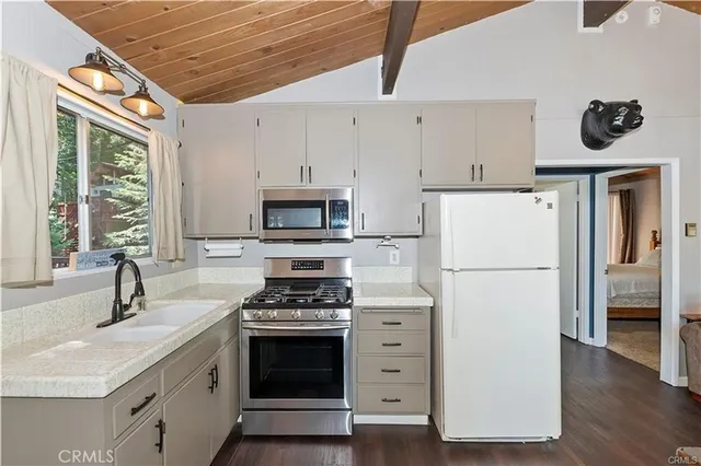 a kitchen with stainless steel appliances a refrigerator sink and cabinets