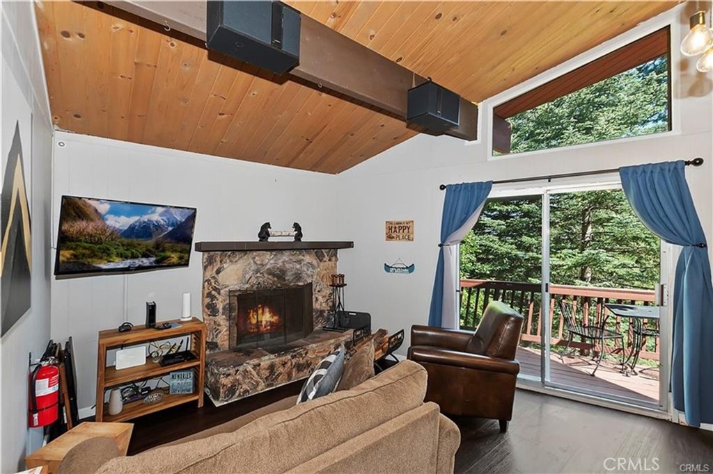 28393 Larchmont Lane Lake Arrowhead, CA 92352 - Photo 9 of 25 a living room with furniture a flat screen tv and a fireplace