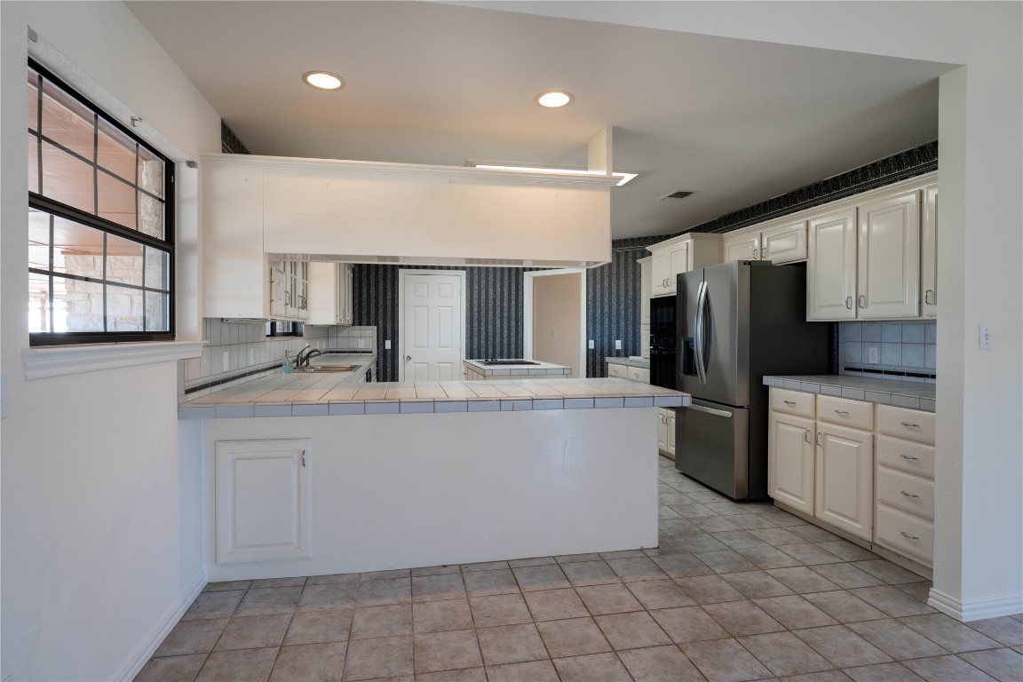 407 Raymond Road La Grange, TX 78945 - Photo 8 of 39 a kitchen with stainless steel appliances a refrigerator sink and microwave