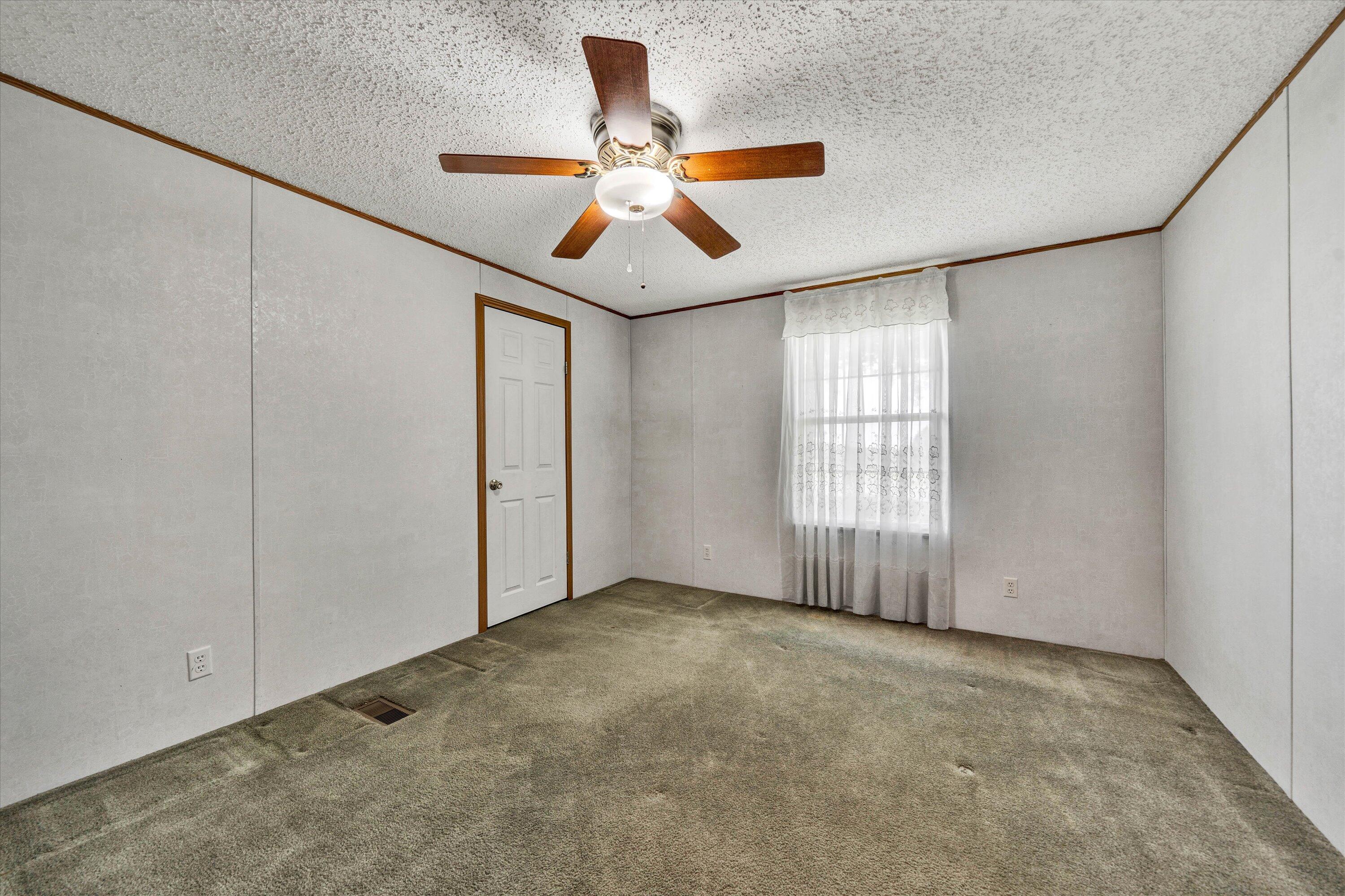 5232 Old Forge Road Rocky Mount, VA 24151 - Photo 31 of 41 an empty room with ceiling fan and window
