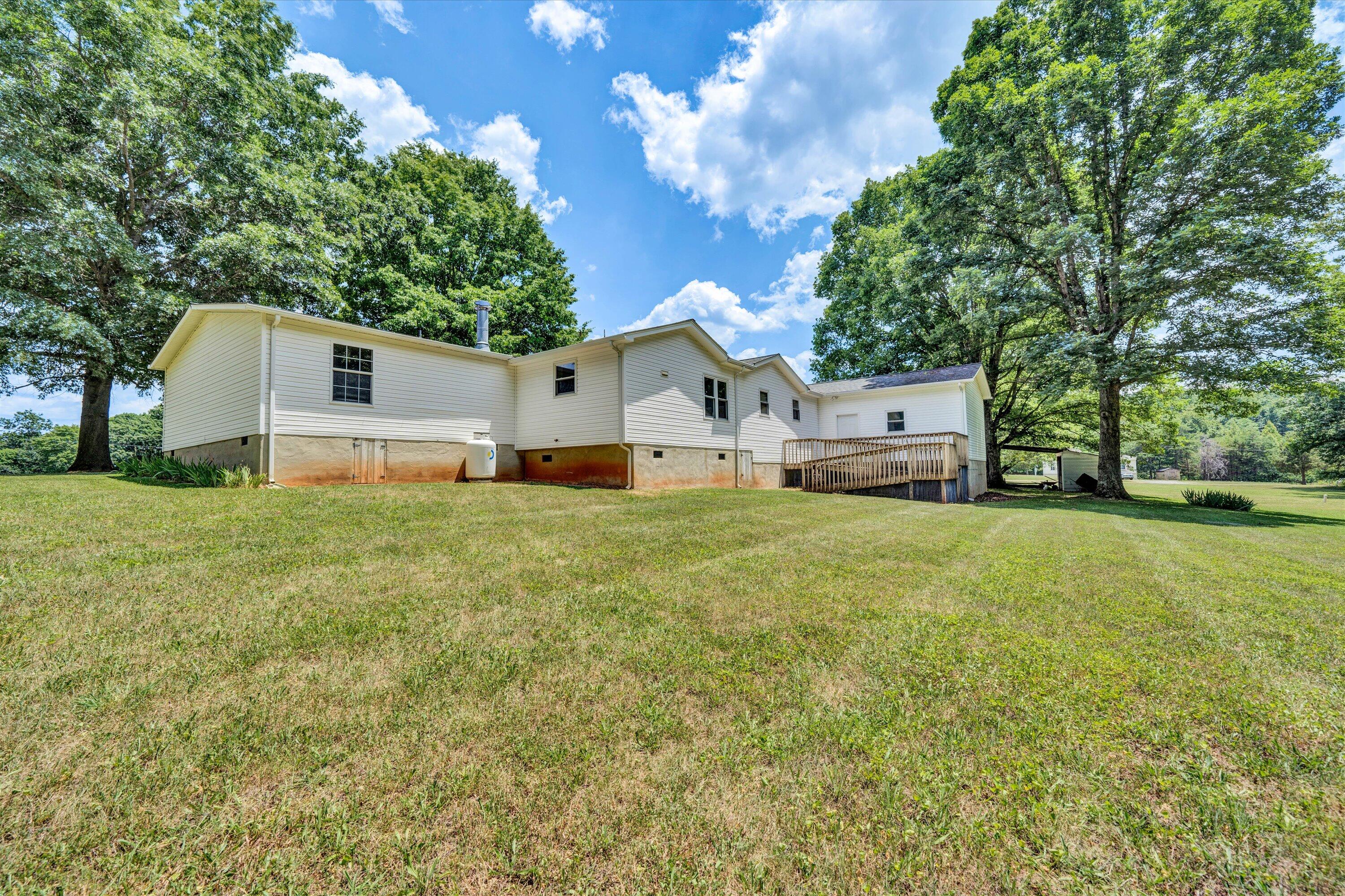 5232 Old Forge Road Rocky Mount, VA 24151 - Photo 36 of 41 a white house that has a tree in front of it