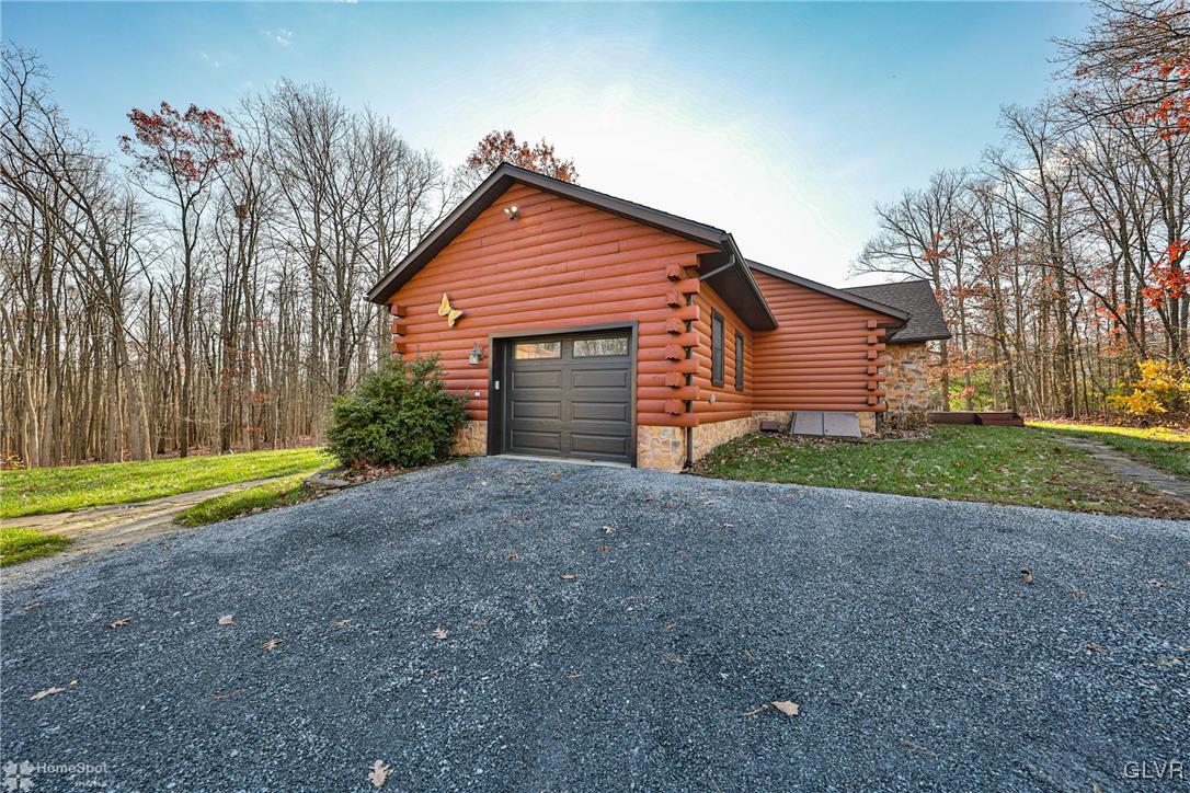2322 Mountain Road Slatington, PA 18080 - Photo 3 of 42 a front view of a house with a yard and garage