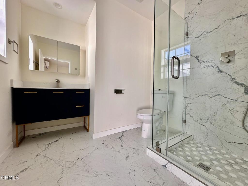 17451 Keswick Street Northridge, CA 91325 - Photo 6 of 8 a bathroom with a toilet sink and shower