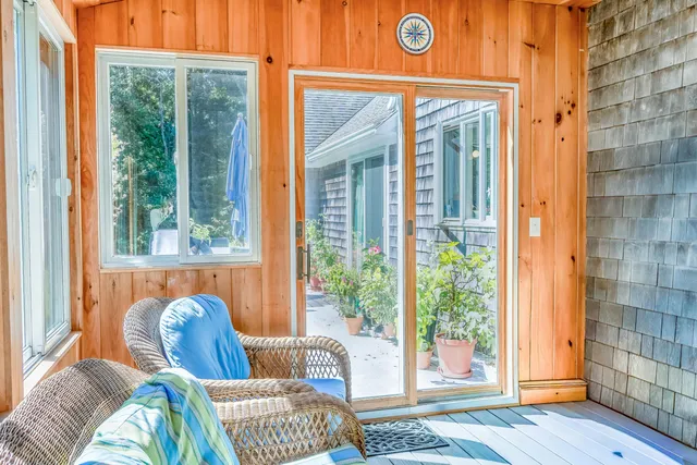 a view of a bedroom with a bed and glass door