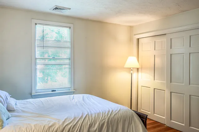 a bedroom with a bed and a window