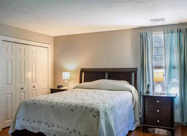 a bedroom with a bed and a window