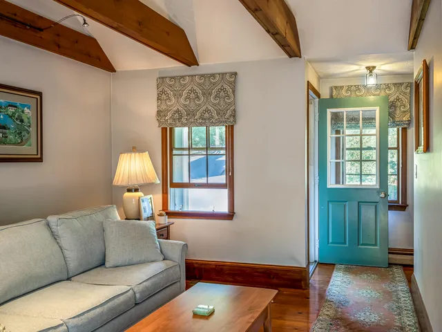 a living room with furniture a window and a chandelier