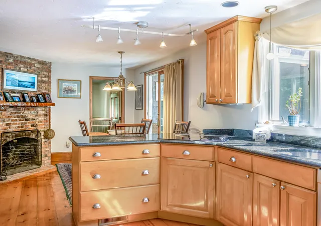 a kitchen with granite countertop a sink and cabinets