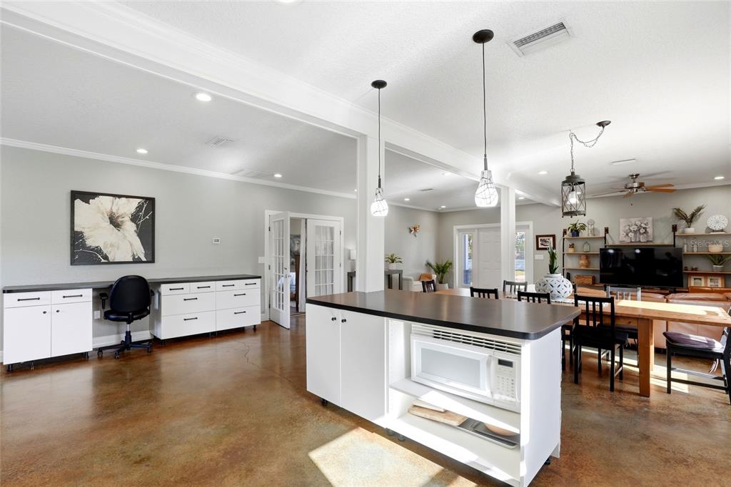 123 South Wiggins Road Plant City, FL 33566 - Photo 13 of 55 a kitchen with stainless steel appliances granite countertop a stove and a view of living room