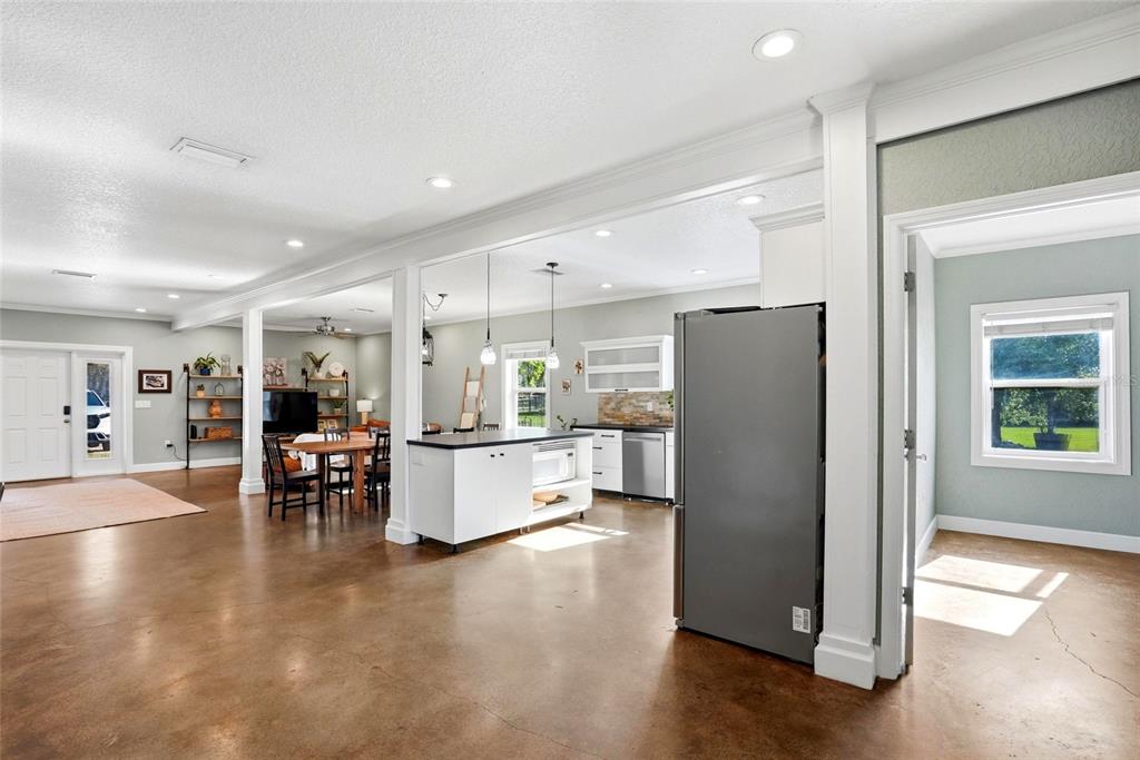 123 South Wiggins Road Plant City, FL 33566 - Photo 14 of 55 a kitchen with a refrigerator and a table chair