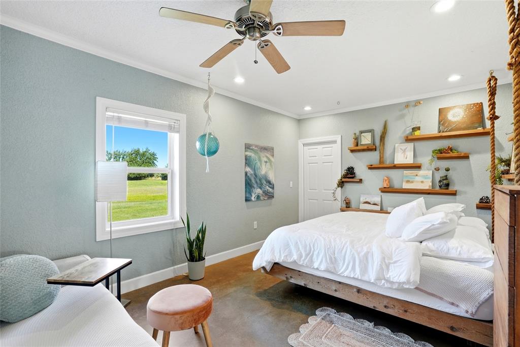 123 South Wiggins Road Plant City, FL 33566 - Photo 15 of 55 a bedroom with a bed and a chandelier