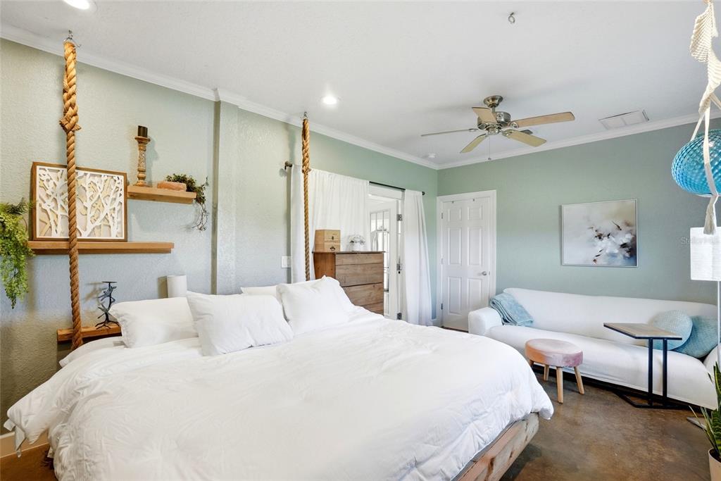 123 South Wiggins Road Plant City, FL 33566 - Photo 16 of 55 a bedroom with a bed a ceiling fan and a rug