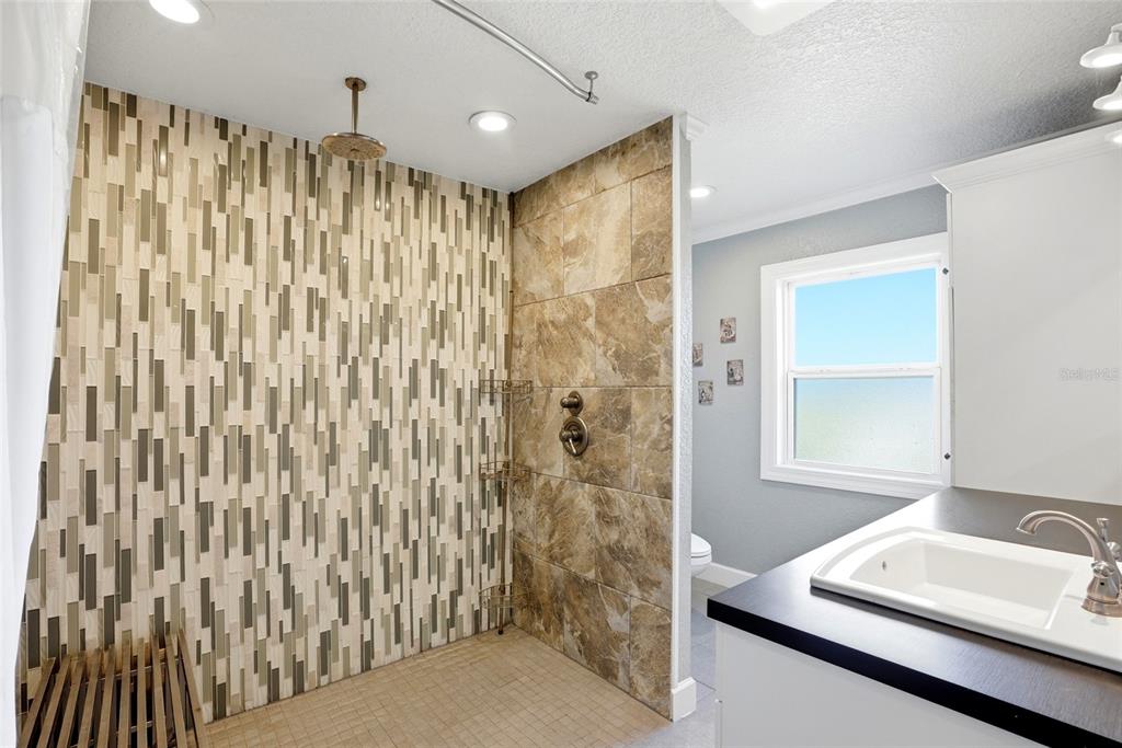 123 South Wiggins Road Plant City, FL 33566 - Photo 17 of 55 a bathroom with a shower curtain and a sink