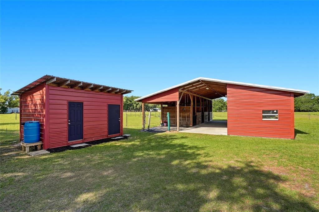 123 South Wiggins Road Plant City, FL 33566 - Photo 2 of 55 a view of a house with a yard and garage