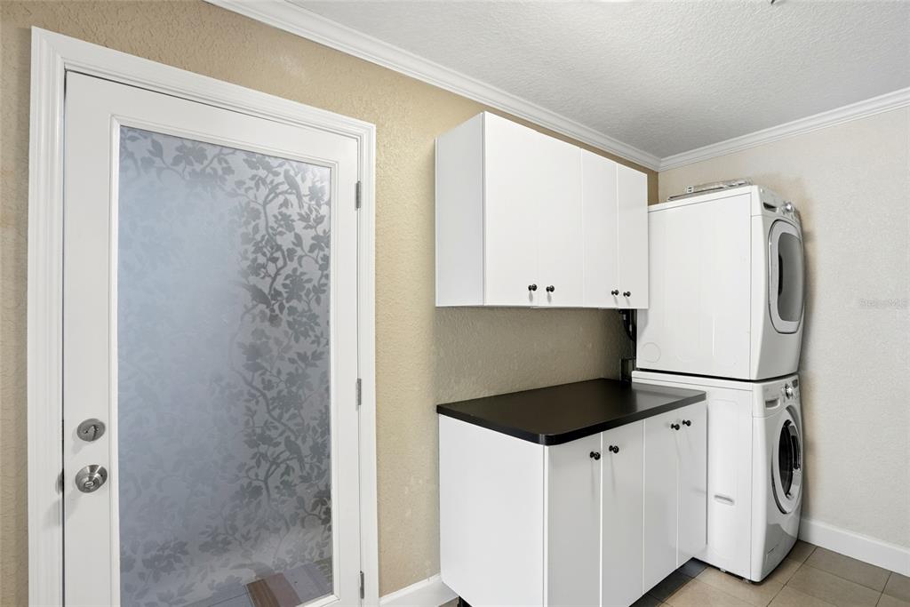 123 South Wiggins Road Plant City, FL 33566 - Photo 21 of 55 a kitchen with a refrigerator and white cabinets