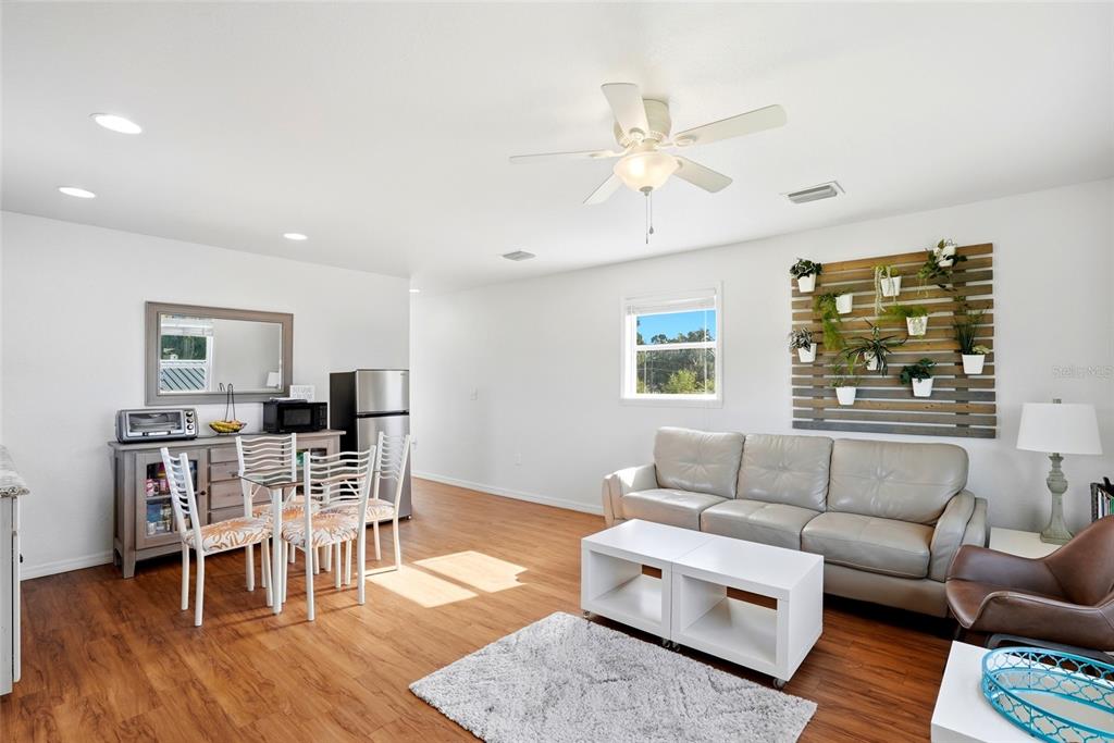 123 South Wiggins Road Plant City, FL 33566 - Photo 24 of 55 a living room with furniture wooden floor and dining table