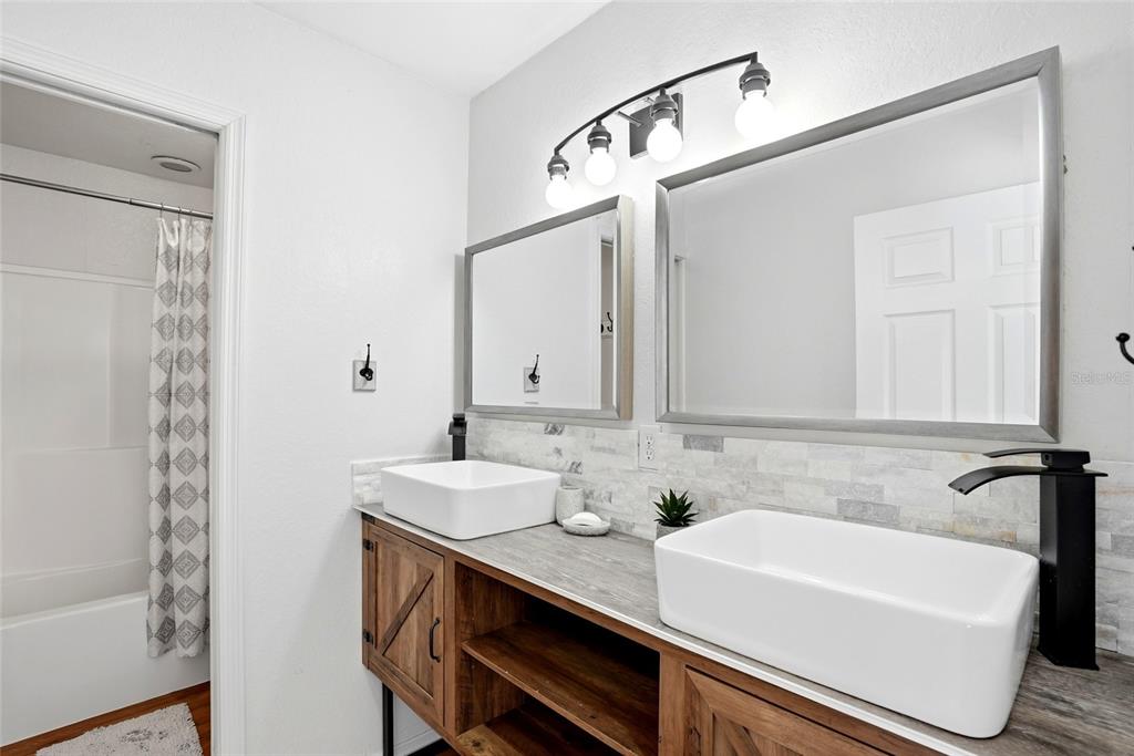 123 South Wiggins Road Plant City, FL 33566 - Photo 28 of 55 a bathroom with a sink and a mirror