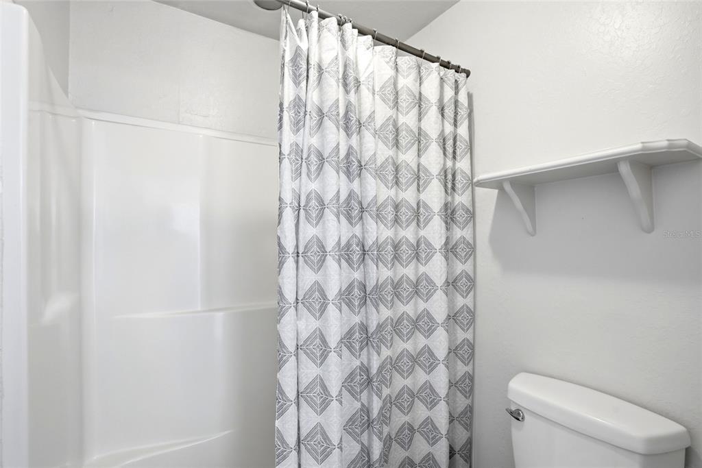 123 South Wiggins Road Plant City, FL 33566 - Photo 29 of 55 a bathroom with a shower curtain and toilet