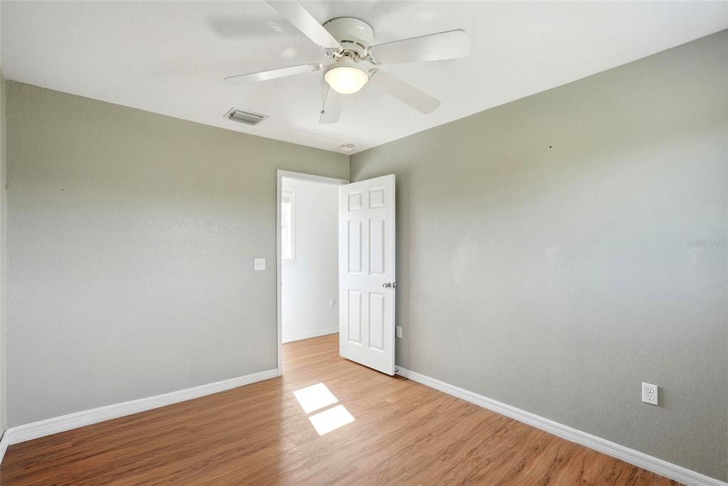 123 South Wiggins Road Plant City, FL 33566 - Photo 33 of 55 an empty room with wooden floor and windows